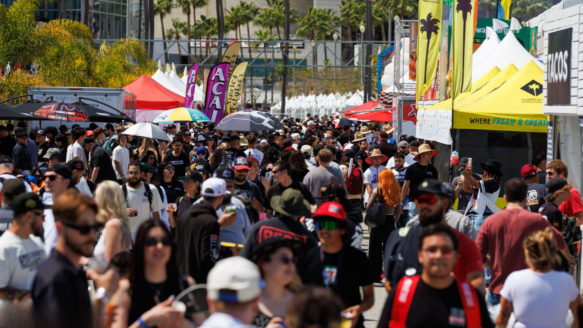 Fan zone full of people walking between activations and food stands