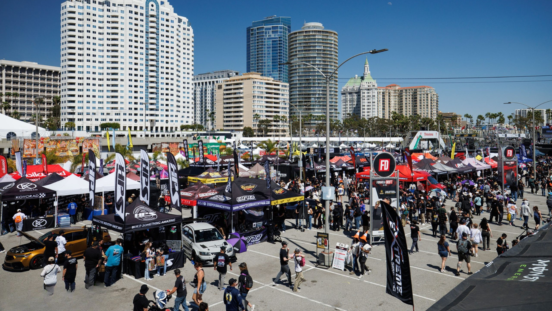 Aerial view of a fan zone packed with stands and crowd